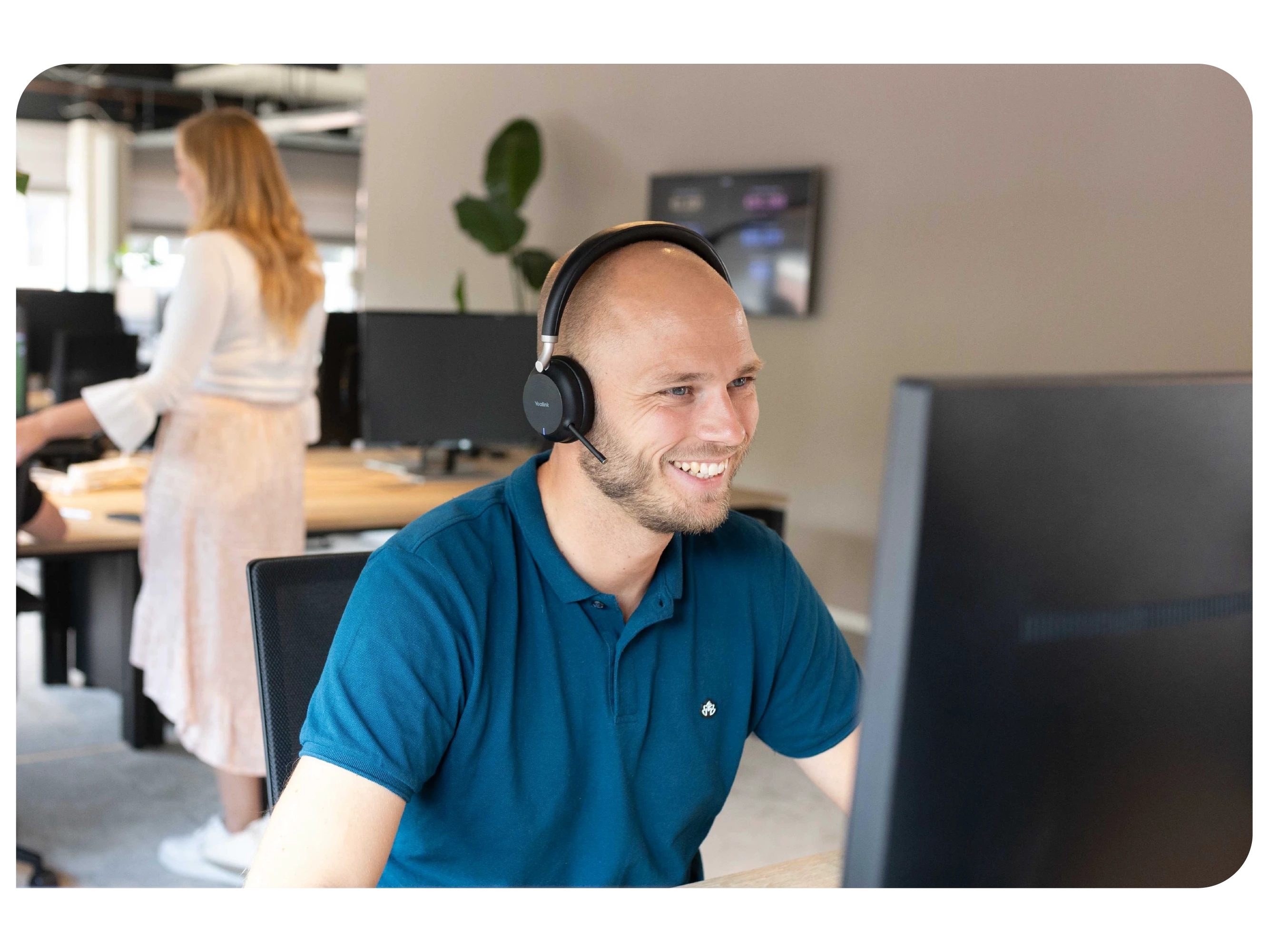 Employee speaking on the phone with a headset.